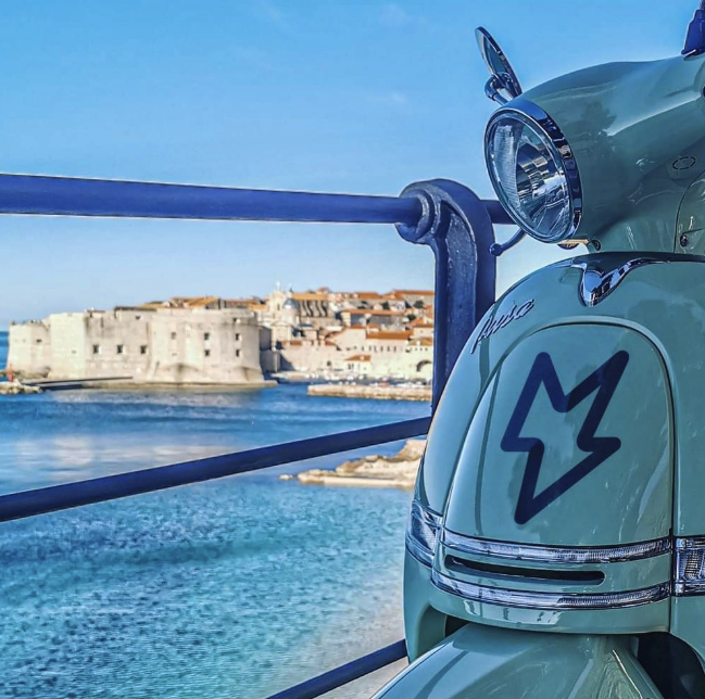 MYNT electric moped with Dubrovnik Old Town in the background